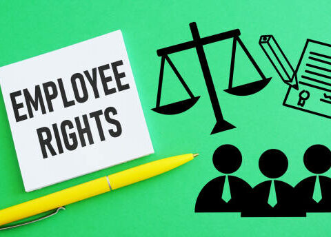 Employment lawyer advising worker on protected workplace rights at office desk